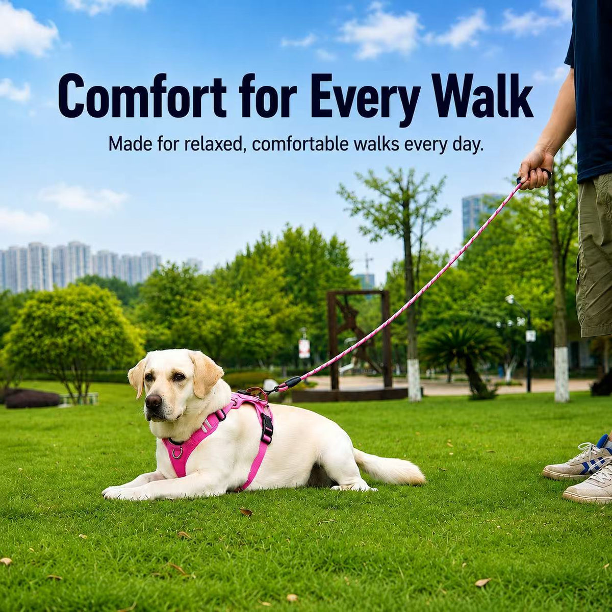 Dog resting on grass wearing a hot pink adjustable no-pull harness