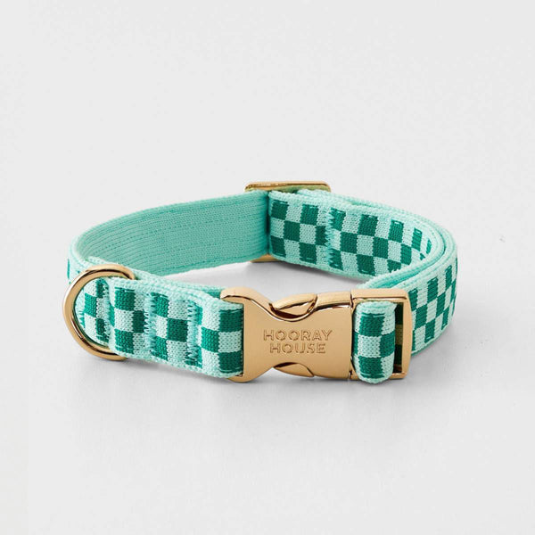 A woven pet collar with a green and white checkered pattern, a mint green interior, and a gold-tone buckle engraved with 'HOORAY HOUSE'.