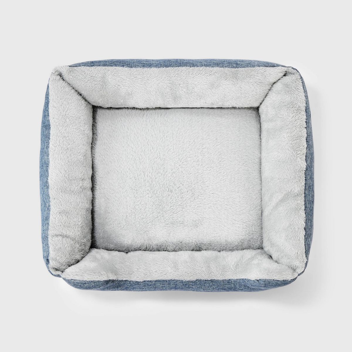 Dog bed with blue and gray pattern on a white background