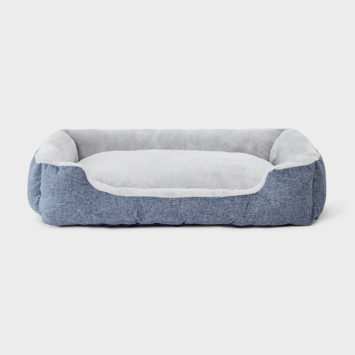 A rectangular plush pet bed with a light gray fuzzy interior and a dusty blue fabric border, shown from a top-down view on a light gray background.